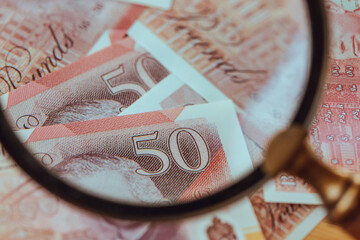 Money of Great Britain. Banknotes of the United Kingdom under the Magnifying Glass. Financial Concept of the UK. close up