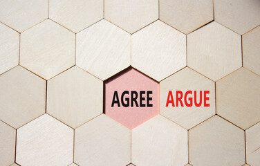 Agree or Argue symbol. Concept word Agree or Argue on wooden comb puzzle. Beautiful pink...