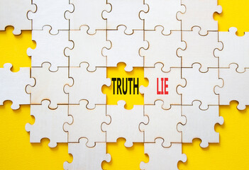Truth or Lie symbol. Concept word Truth or Lie on wooden puzzle. Beautiful yellow background....