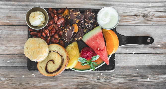Charcuterie breakfast platter on wood table 