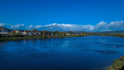 Wide View of River Shannon and Colorful Limerick Skyline on Sunny Day