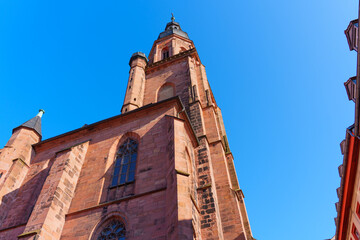 Historic Church Tower Reaching Towards Blue Sky in Heidelberg Germany