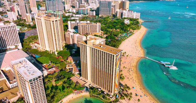 Beautiful luxury hotels surrounded by the lush greenery. Footage above the iconic beach in Waikiki, Honolulu, Hawaii, USA.
