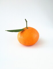 Mandarin fruit with leaves, on light background, the mandarin orange, Citrus reticulata