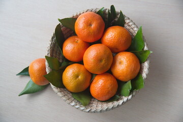 Mandarin fruit with leaves, woven basket, the mandarin orange, Citrus reticulata