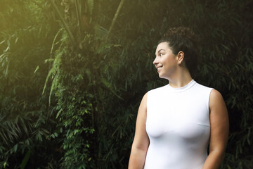 Happy woman in tropical forest, space text copy