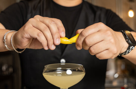 Bartender Expressing Lemon on a Martini