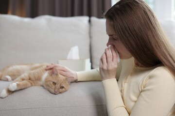 Woman suffering from allergy with her cat at home