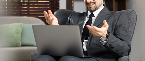 Professional psychologist having online consultation with his client via laptop indoors, closeup