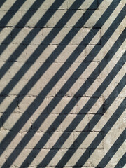 Grey concrete flooring with patterns reminiscent of ancient stonework with bricks and wooden...