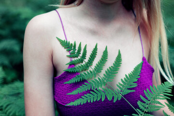 hipster woman with fern leaf embracing. girl with natural herb. romantic moment. 