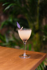 sour cocktail drink with ice cubes. Pisco sour alcohol cocktail on blur background surface.