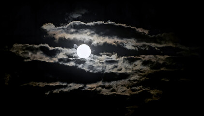 long exposure of the moon with clouds passing through at night © C. Gaines Media