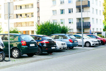 Long row of cars parking tightly along city road street.Urban transportation infrastructure problems in residential district.vehicles parked by curb.