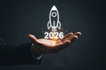 Business Launch 2026: Hand Holding Glowing Rocket Start-up Concept
