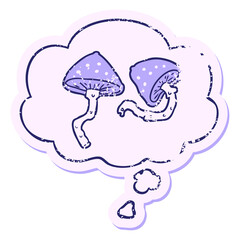 cartoon mushrooms with thought bubble as a distressed worn sticker in bright neon color
