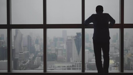 Meditative businessman in break admiring the city view from big window of office - Powered by Adobe