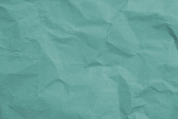 Obraz premium Crumpled teal paper with wrinkled and textured background