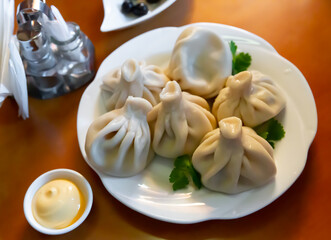 Appetizing khinkali on a plate closeup. Georgian cuisine