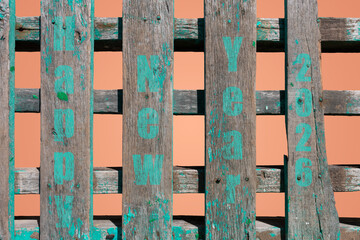 Happy new year 2026 written on rustic wood strips.