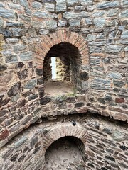 Stone fortress wall with arches and perched pigeon