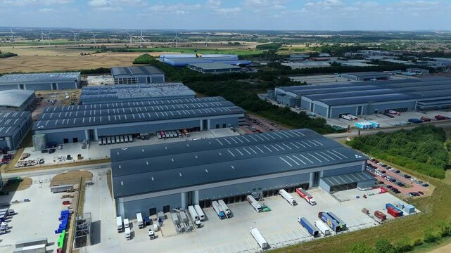 Aerial drone perspective distribution centers and industrial warehouses and data centers centres Quantum computing business hub super market distributor near Biggleswade England UK