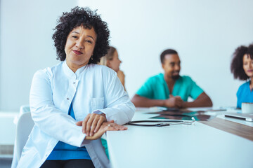Confident Female Doctor with Medical Team Meeting in Bright Office