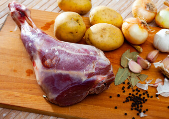 Raw lamb leg with natural ingredients before cooking, nobody