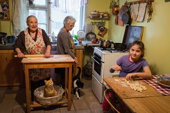 family cooking and doing lessons in kitchen