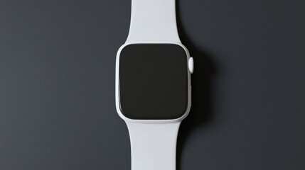 A modern smartwatch with sleek design lies centered on a dark surface, offering a blank screen for versatile use, blending technology and minimalism.