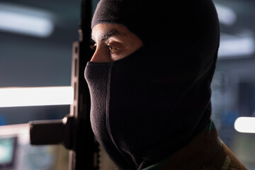 Secret service agent checking weapons in headquarters base, ensuring enough ammunition. Masked...