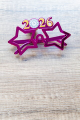 new year resolutions 2026 glasses with numbers 2026 on wooden desk with copy space. vertical photo, happy new year