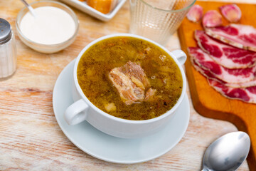 National dish of Russian cuisine is cabbage soup, cooked in thick broth and on the basis of...