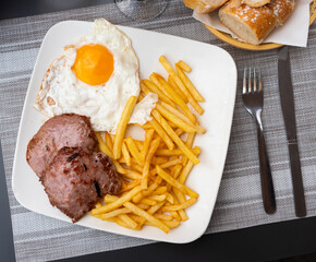 Traditional spanish food, Eggs con hamburgesa y patata, steak meat with potato and eggs
