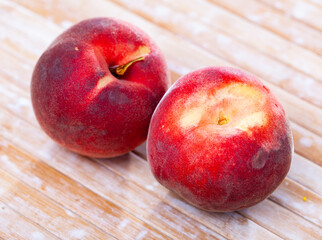 Fresh organic peaches on wooden background, fruit vegan food