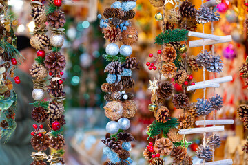 View of hanging Christmas decorations presented on a blurry background. Close-up image