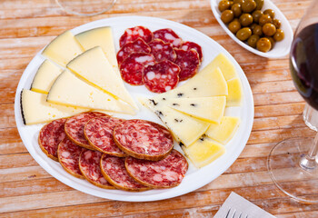 Cured meat platter with cheese and spanish sausages, slices and cuts