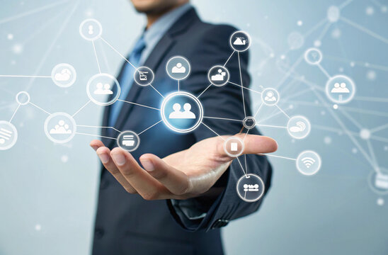 "Corporate technology concept: a close-up view of a suited professional’s hand presenting a holographic digital communication network. Social icons, chat bubbles, and emoticons hover and rotate in 3D 