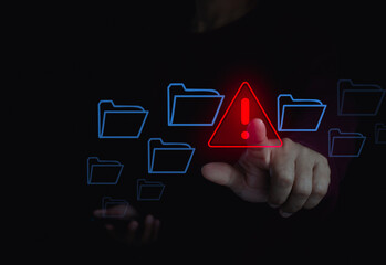 Cybersecurity technology warning alert with hand touching digital folder on laptop computer in...