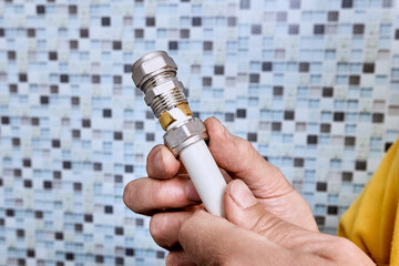 Tightening nut onto threaded coupling causes compression ring to press against multilayer pipe and secure fitting inside pipe for plumbing connection.