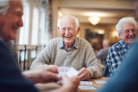 Elderly Friends Enjoying a Game of Cards - Powered by Adobe