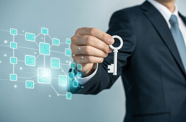 "Close-up of a man’s hand in a business suit holding a white holographic key hovering over a futuristic interface of interconnected teal squares and lines. The scene is minimalistic with a light blue-