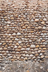 Unique arrangement of smooth stones creates a textured surface under bright sunlight in a serene...
