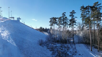 There are rope tow and chair elevators on the slopes of the ski center. Skiers climb them. Along...