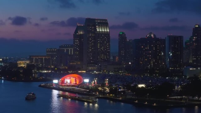 The breathtaking aerial view of downtown San Diego captured during the night showcases an array of vibrant city lights that beautifully contrast with the deep hues of the twilight sky above it
