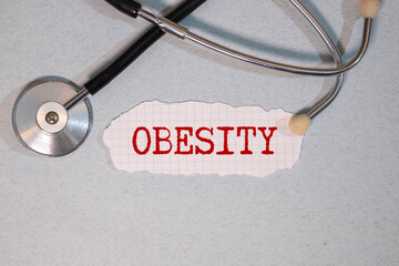 a doctor showing a signboard with the word obesity written in it