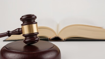 Wooden gavel and open book symbolizing justice