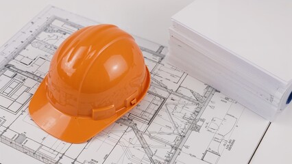 Construction safety helmet on blueprints