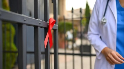 Healthcare professional ties symbolic red ribbon, awareness and support