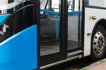 Entrance of a modern public transport bus with closed doors